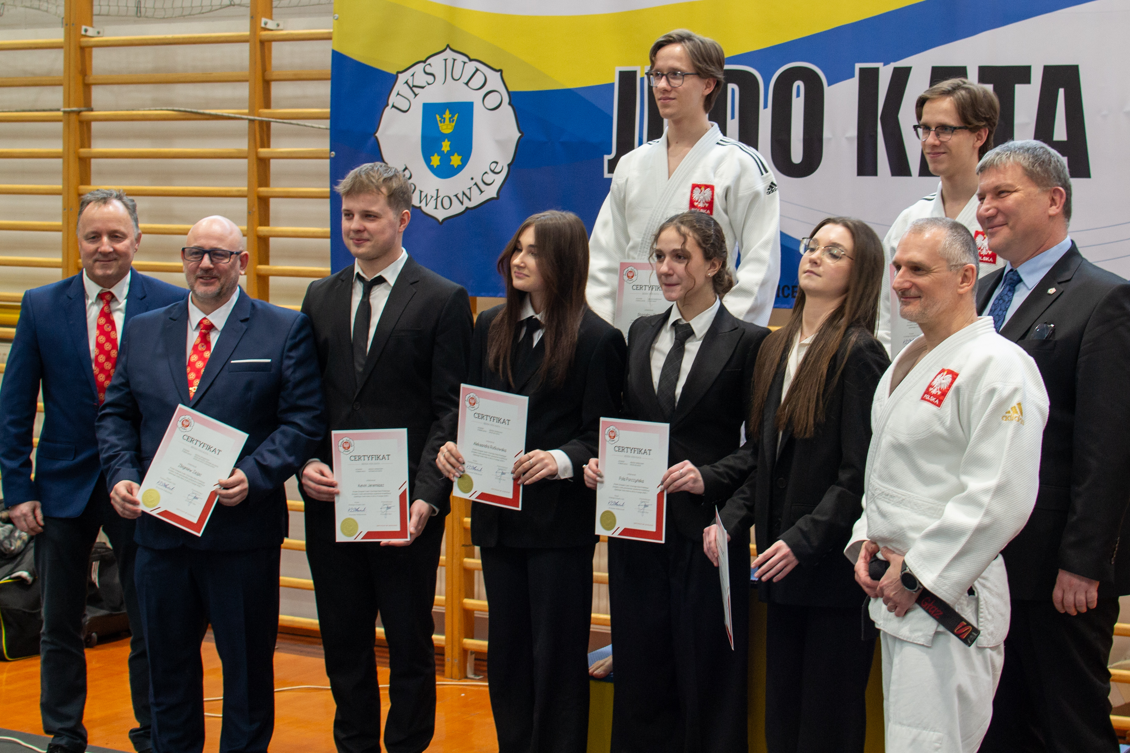 Grupa sędziów judo kata trzyma w rękach certyfikaty